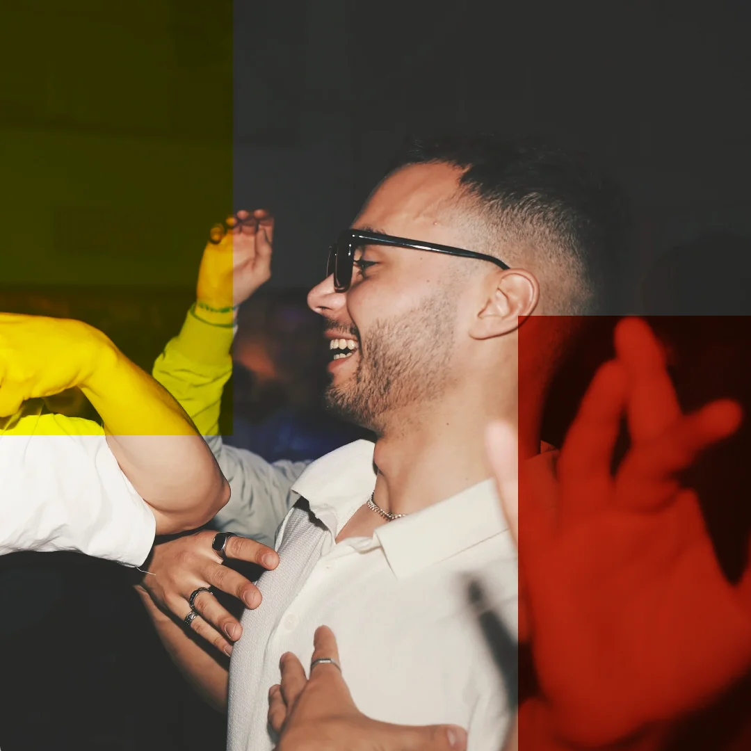 Editing Room: a man in glasses laughing among raised hands
