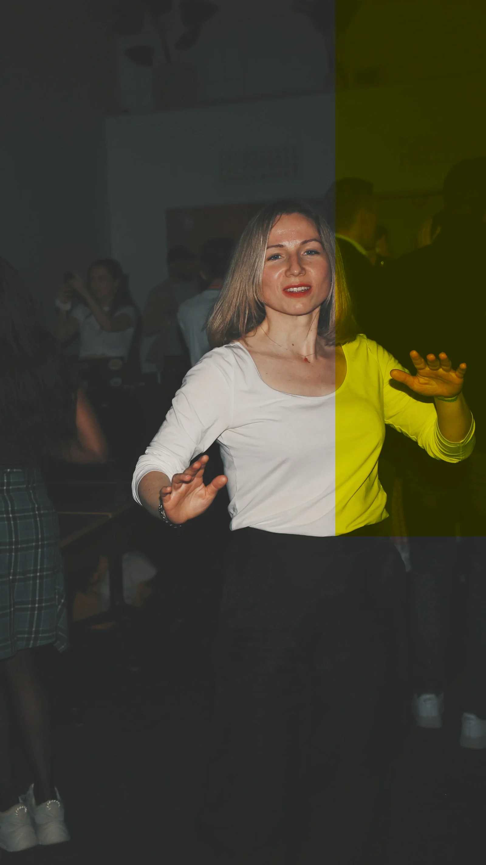 A woman in a white top dancing