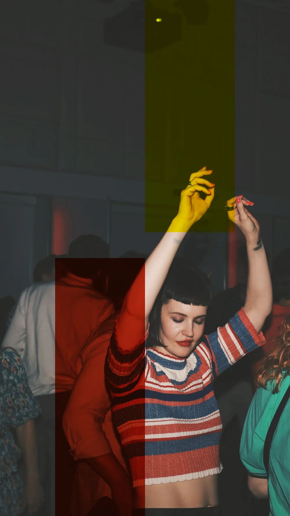 A woman in a striped top dancing with her arms up