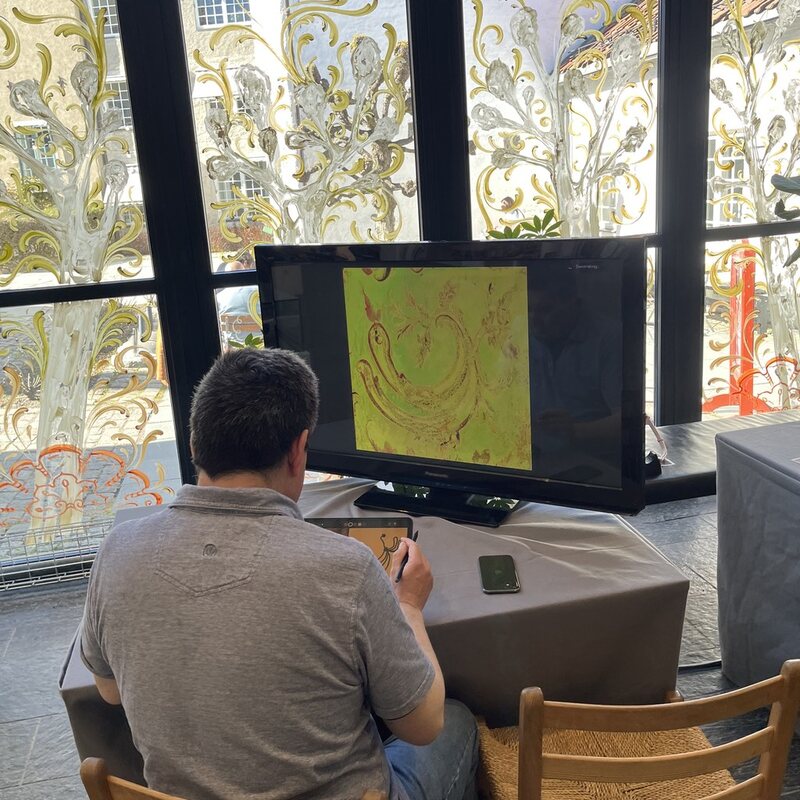 A visitor drawing at the installation