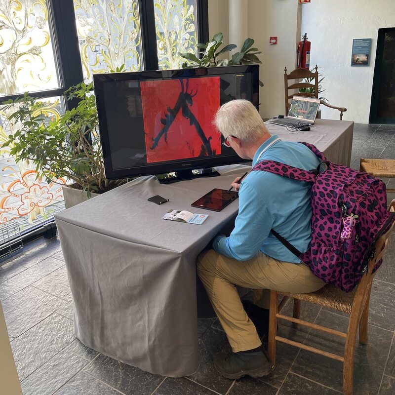 A visitor drawing at the installation