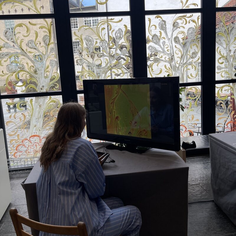 A visitor drawing at the installation